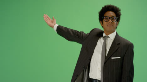Businessman-gestures-with-one-arm-on-green-screen